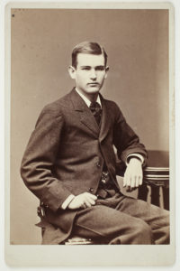 Carte-de-visite of a young white man, seated, wearing a tweed suit and facing the camera.