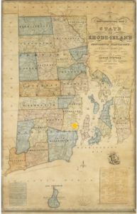 Multi-colored state map with towns delineated. A yellow star is on the southeast border of North Kingstown.